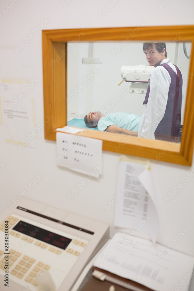Obraz premium View of doctor doing a radiography through a window