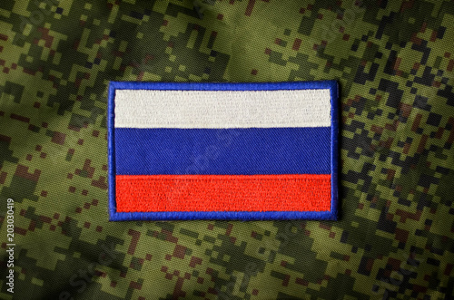 Russian national flag, military chevron on camouflage background
