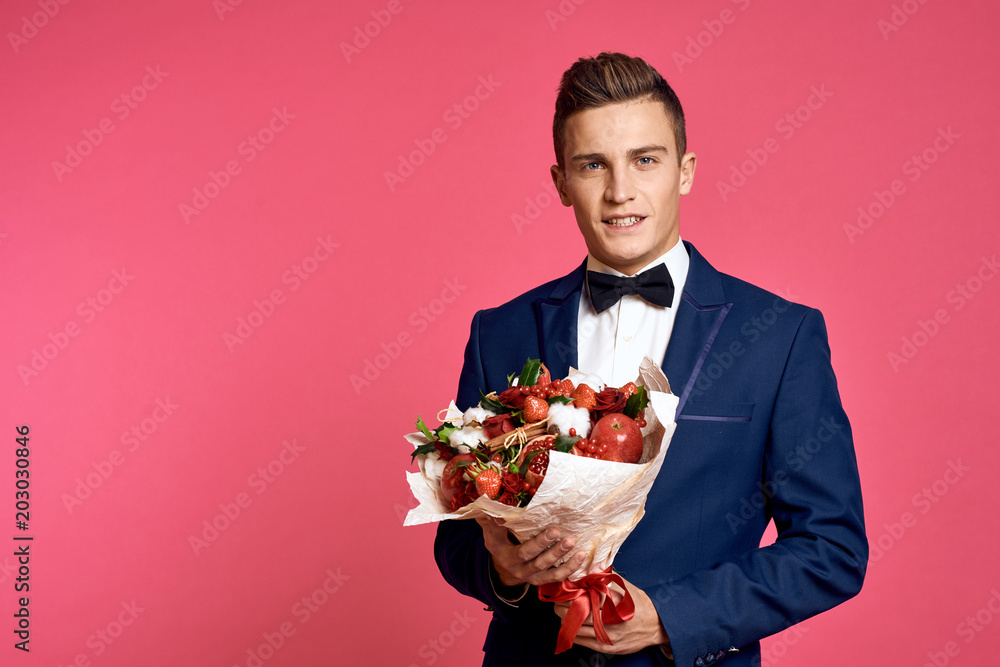 elegant gentleman with a bouquet of flowers and fruits elegant gentleman with a bouquet of flowers and fruits
