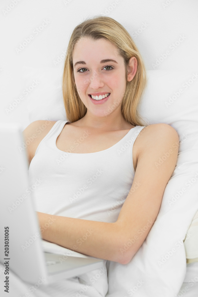 Content calm woman using her notebook smiling at camera Content calm woman using her notebook smiling at camera
