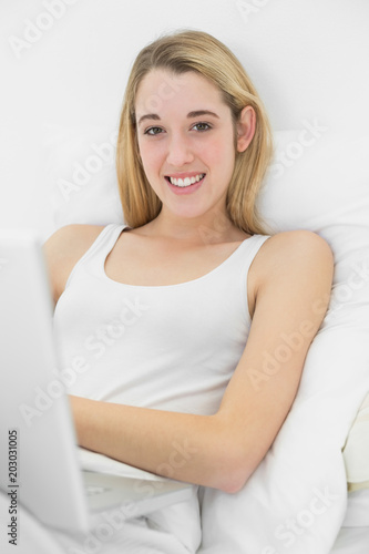 Content calm woman using her notebook smiling at camera Free Download Content calm woman using her notebook smiling at camera - GFXLoad