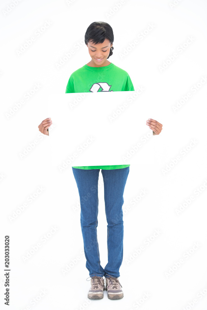 Amused black haired ecologist holding a white panel in front of her Amused black haired ecologist holding a white panel in front of her