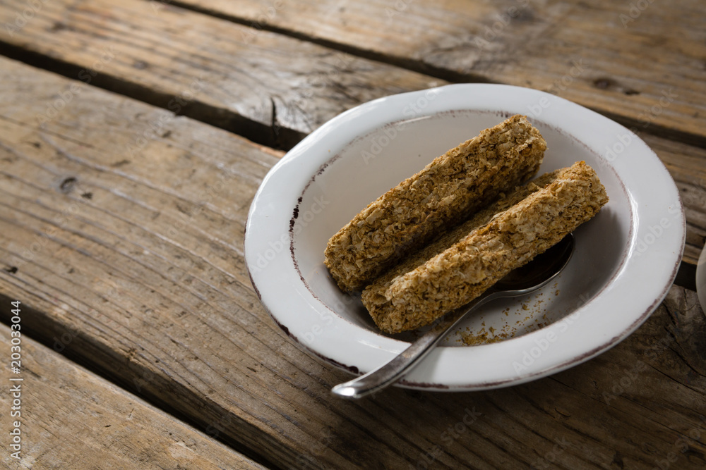 Granola bar in bowl on wooden table Granola bar in bowl on wooden table