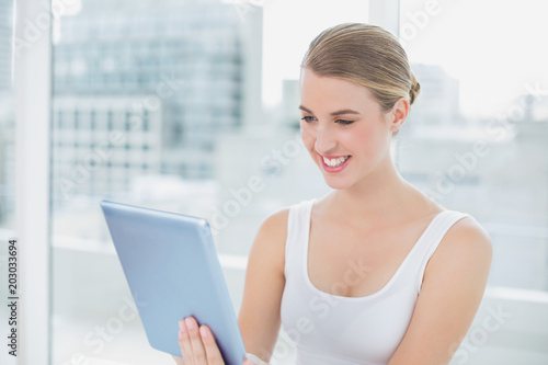 Cheerful cute blonde holding digital tablet Free Download Cheerful cute blonde holding digital tablet - GFXLoad