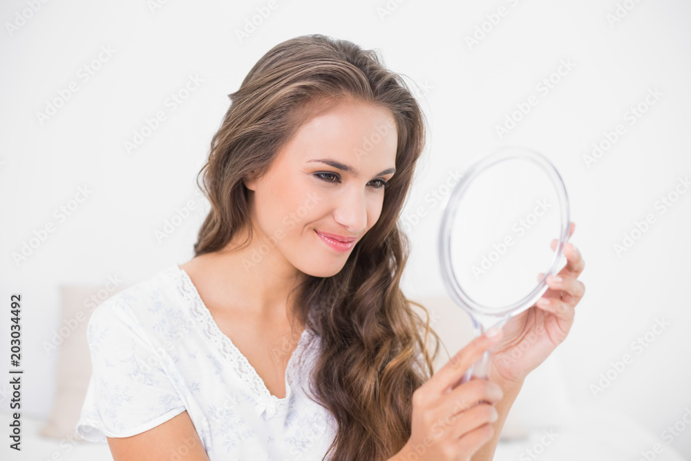 Grinning attractive brunette looking at mirror Grinning attractive brunette looking at mirror