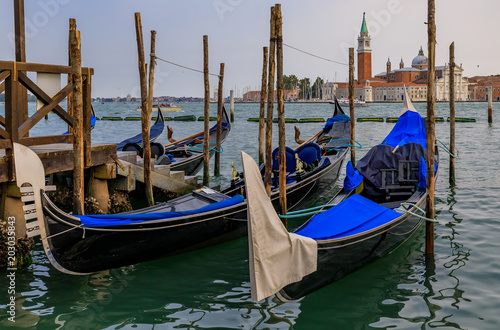 Gondolas along Grand Canal at St Marco square with San Giorgio Maggiore church in Venice Italy