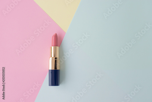 Flat lay of creative female cosmetic for pink lipstick on the colorful background with copy space photo