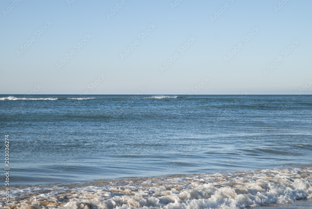 Sea waves on a beach ocean background in sunny day