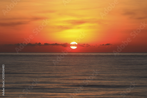 An image of a nice red sunset with a big yellow sunset © nelzajamal