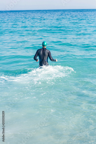 Swimmer running in the ocean