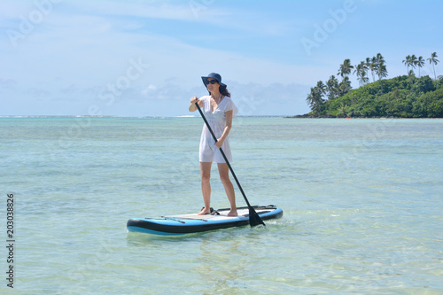 Young woman on a Stand Up Paddle Board paddle boarding