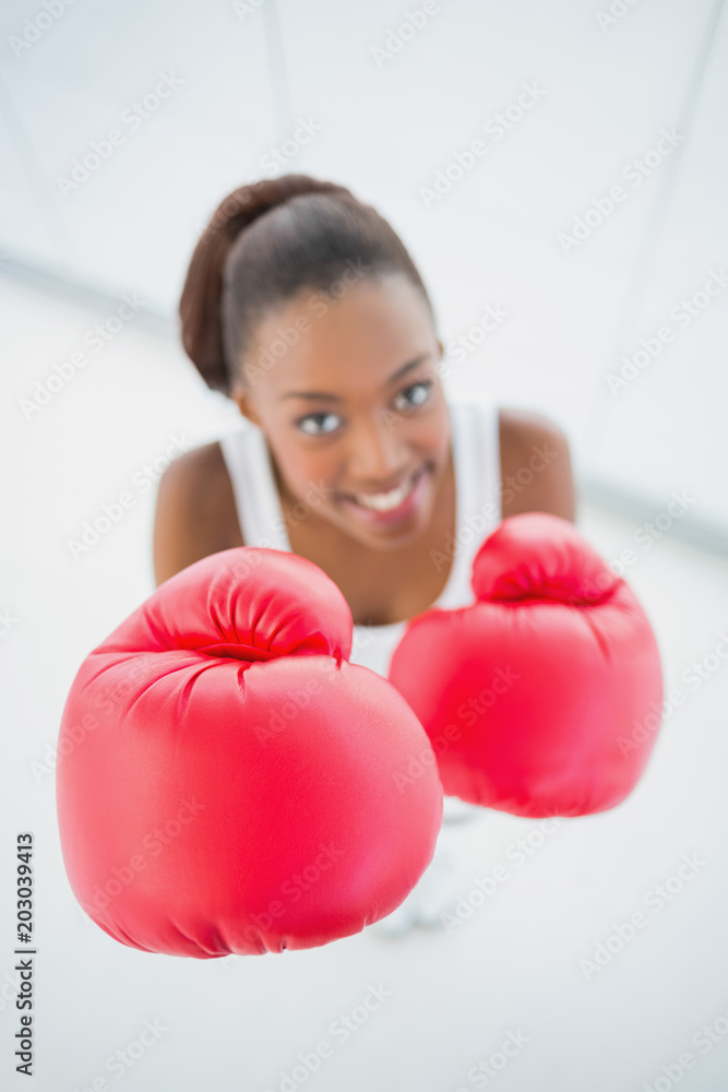 High angle view of happy fit woman with red boxing gloves High angle view of happy fit woman with red boxing gloves