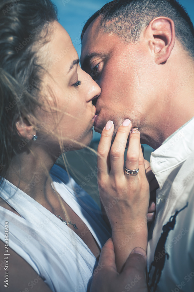 Kissing couple at beach, sea view. Traveling at Thailand, Phuket Kissing couple at beach, sea view. Traveling at Thailand, Phuket