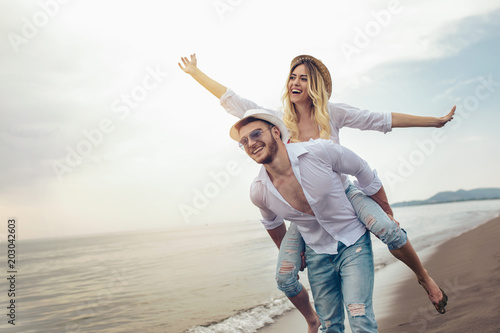 Fototapeta Happy couple in love on beach summer vacations