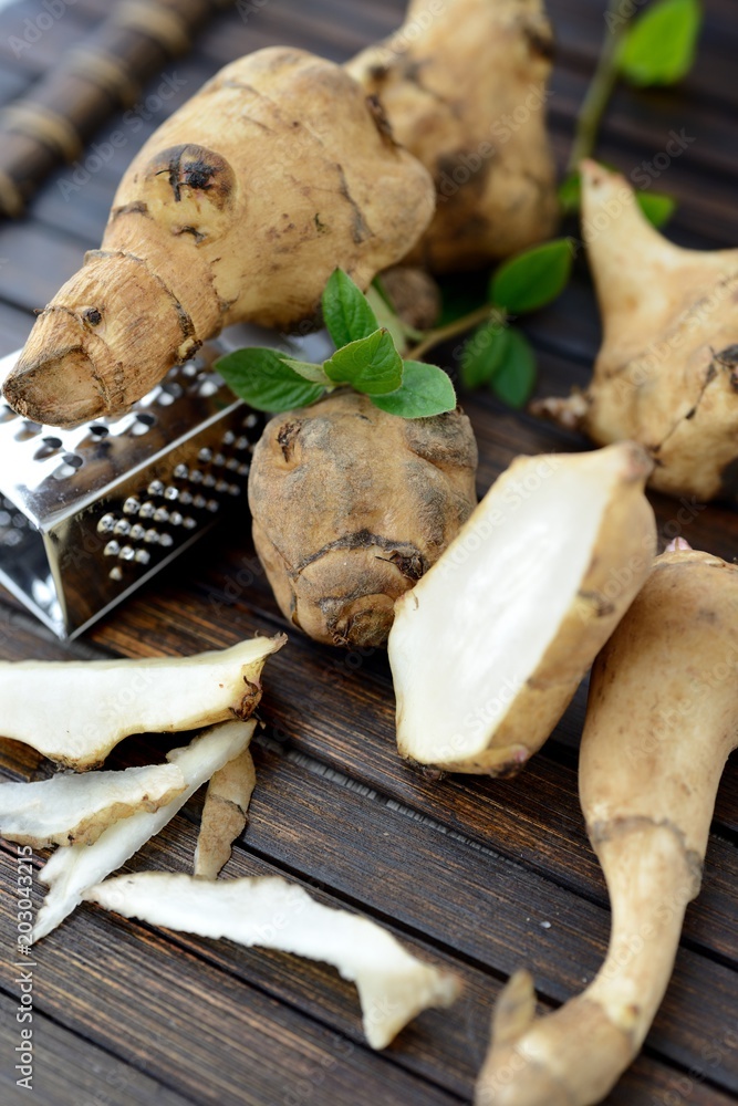 Jerusalem artichoke on a wooden table Jerusalem artichoke on a wooden table
