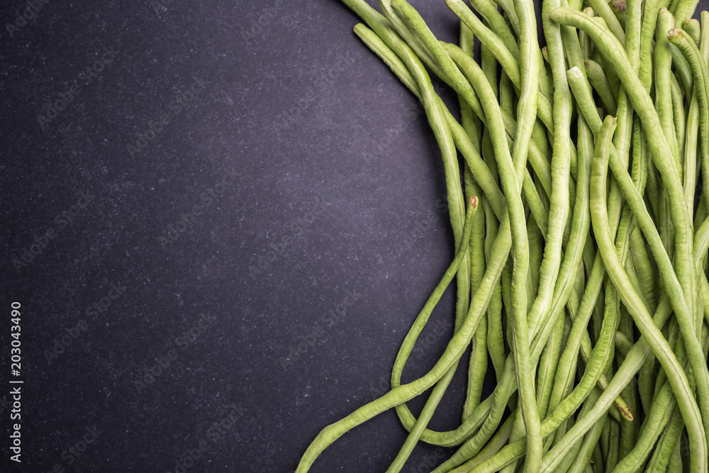 Top view fresh green cowpea or Asparagus bean on black stone Top view fresh green cowpea or Asparagus bean on black stone