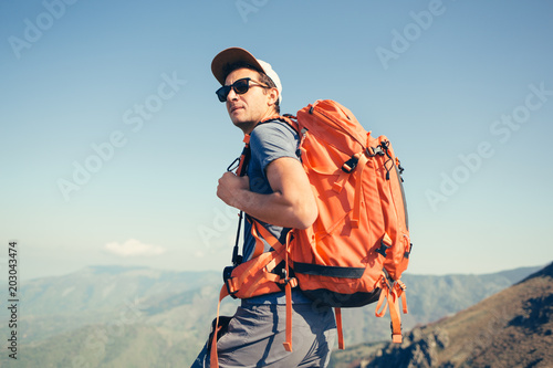 Portrait of backpacker posing in the mountains photo