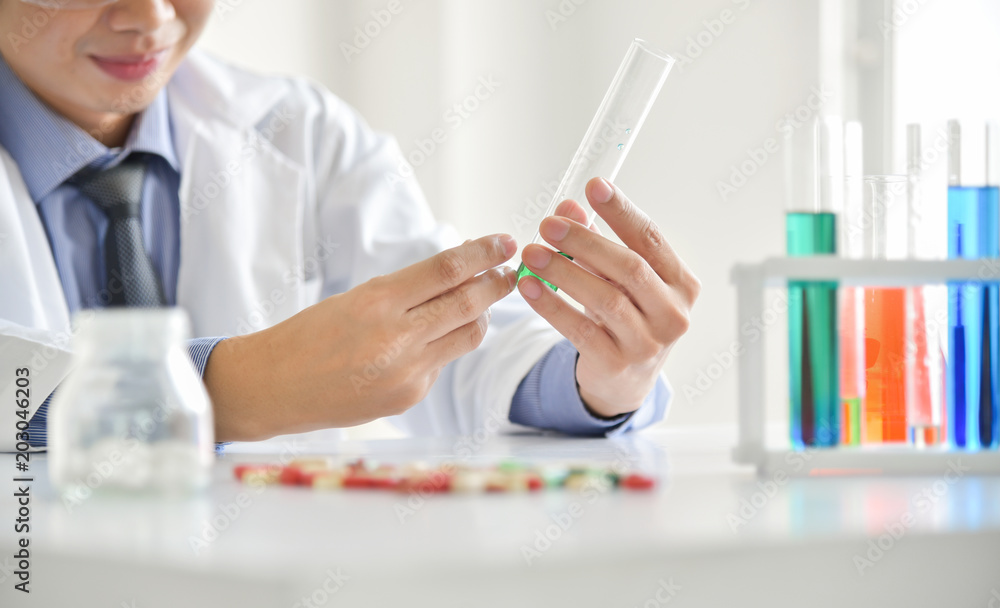 Research Scientist is Using Micropipette Filling Test Tubes. Research Scientist is Using Micropipette Filling Test Tubes.