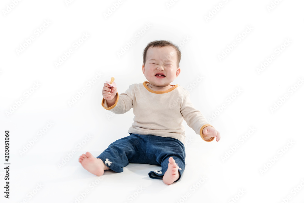 The baby is playing on the floor, the white background The baby is playing on the floor, the white background