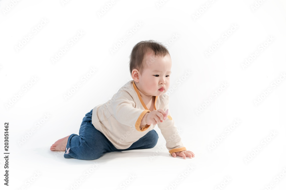 The baby is playing on the floor, the white background The baby is playing on the floor, the white background