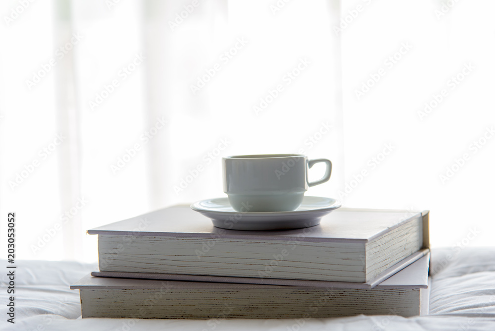 Early Work day. Cup coffee and book in morning with sun light. Lifestyle Concept Early Work day. Cup coffee and book in morning with sun light. Lifestyle Concept