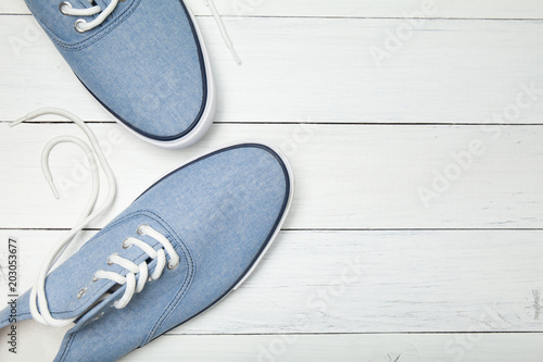 Casual sneakers on a white background, top view. Copy space for text.