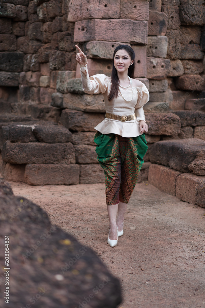 beautiful woman inThai traditional dress is pointing beautiful woman inThai traditional dress is pointing
