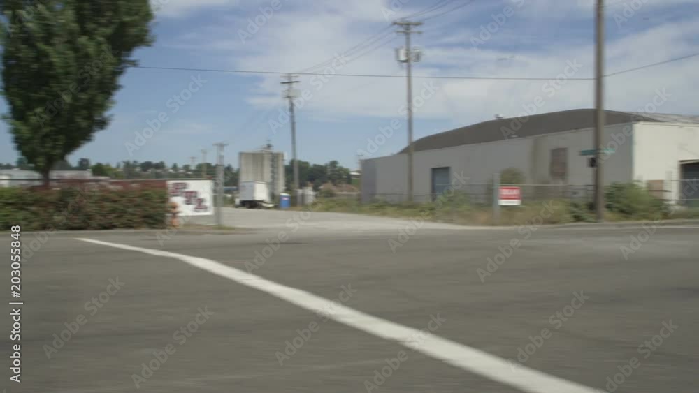 Left Side view of a Driving Plate: Car travels on NW Front Avenue in Portland, Oregon, turns right onto NW Nicolai Street, and continues past industrial warehouses and power substations to stop at the intersection of Oregon Highway 30. Left Side view of a Driving Plate: Car travels on NW Front Avenue in Portland, Oregon, turns right onto NW Nicolai Street, and continues past industrial warehouses and power substations to stop at the intersection of Oregon Highway 30.