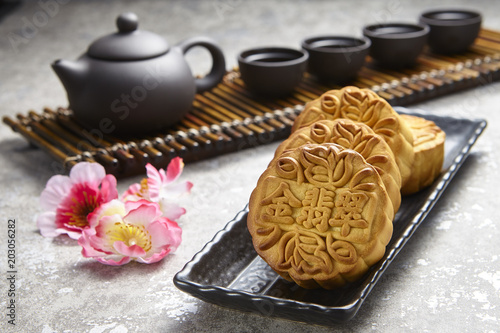 Golden Emerald mooncake on wooden table. Chinese mid autumn festival foods