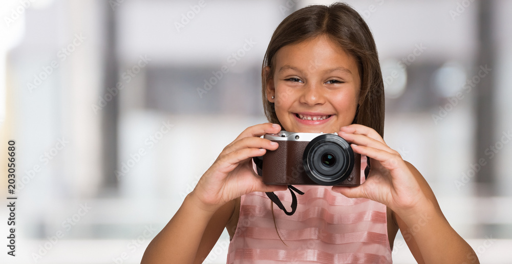 Smiling child holding a camera Smiling child holding a camera