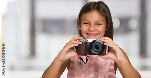 Smiling child holding a camera