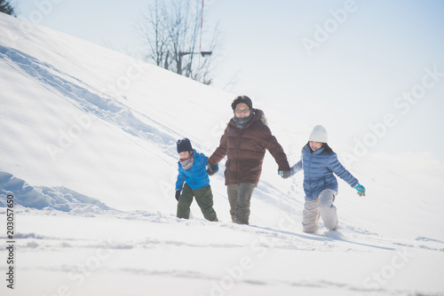 father and his children holding hands and walking