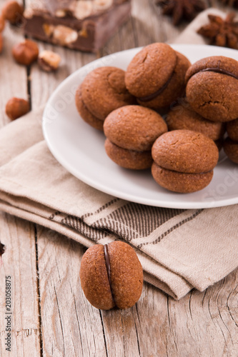 Fényképezés Hazelnut shortbread sandwiches filled with chocolate cream.