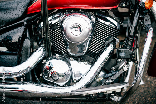 Closeup of motorbike with lots of chrome details. Modern powerful perfomance road motorcycle shiny reflexive surface engine with exhaust pipes. Vehicle industry. Two-wheeled vehicle technologies.