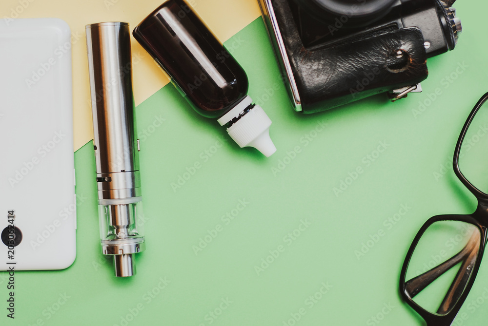 Vaping set and coffee on the colorful background. Hipster or bussinesman style. Vaping set and coffee on the colorful background. Hipster or bussinesman style.