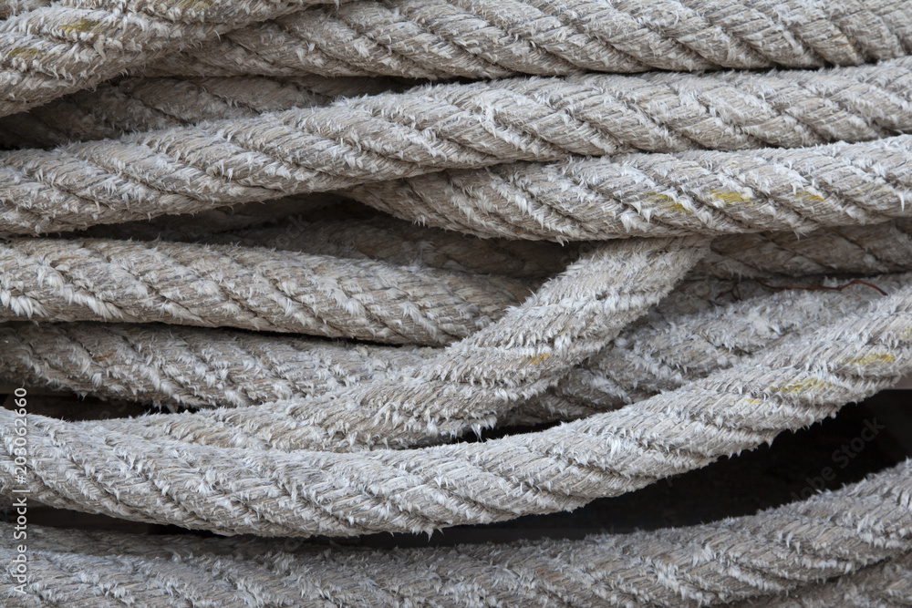 Thick braided rope. Texture of a braided rope. Fishing net.