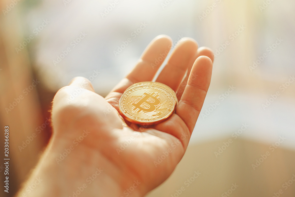 hand holding shiny golden bitcoin, gold money. digital currency, bit coin on people palm, cryptocurrency concept.space for text, money modern investment. luxury network currency hand holding shiny golden bitcoin, gold money. digital currency, bit coin on people palm, cryptocurrency concept.space for text, money modern investment. luxury network currency