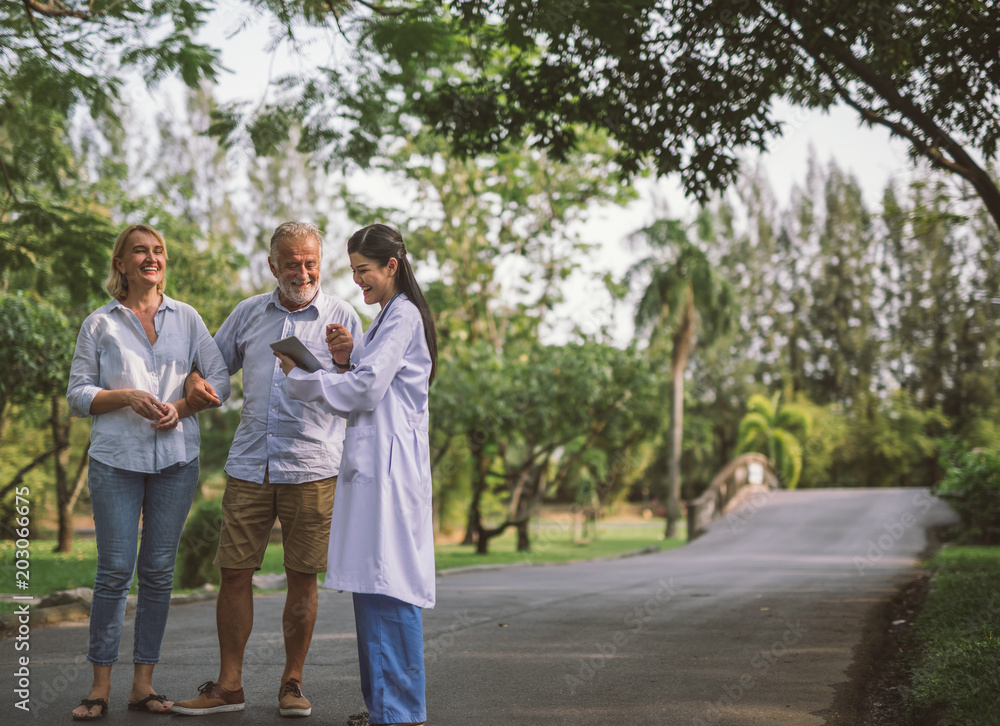 Elderly and Doctor talking about health healthcare consultant in a park. Elderly and Doctor talking about health healthcare consultant in a park.