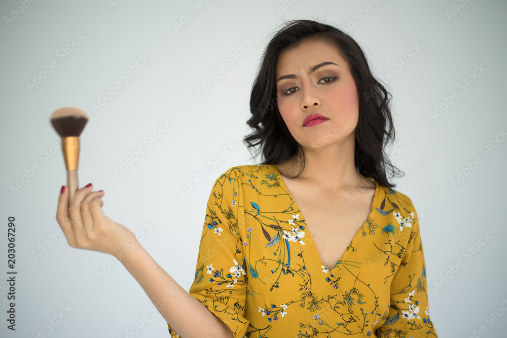 young beautiful woman touch with powder brush on white background
