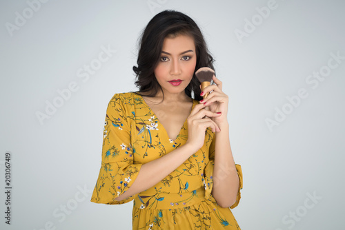 young beautiful woman touch with powder brush on white background