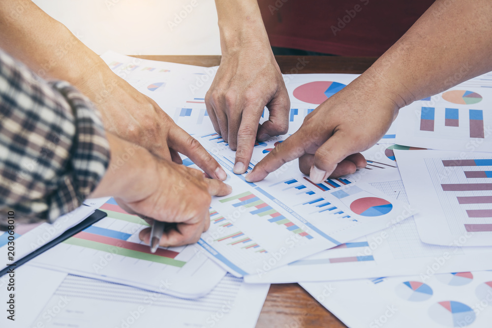 Start up business. people team work meeting point to discuss the graph up and down of economy and work on tablet.Selective Focus Start up business. people team work meeting point to discuss the graph up and down of economy and work on tablet.Selective Focus