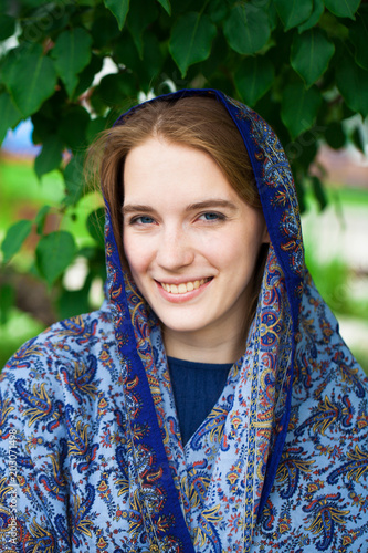 Happy young blonde woman in blue scarf