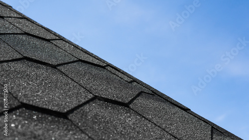 Bild auf Leinwand The texture of the roof tiles shingles with a blue sky on background