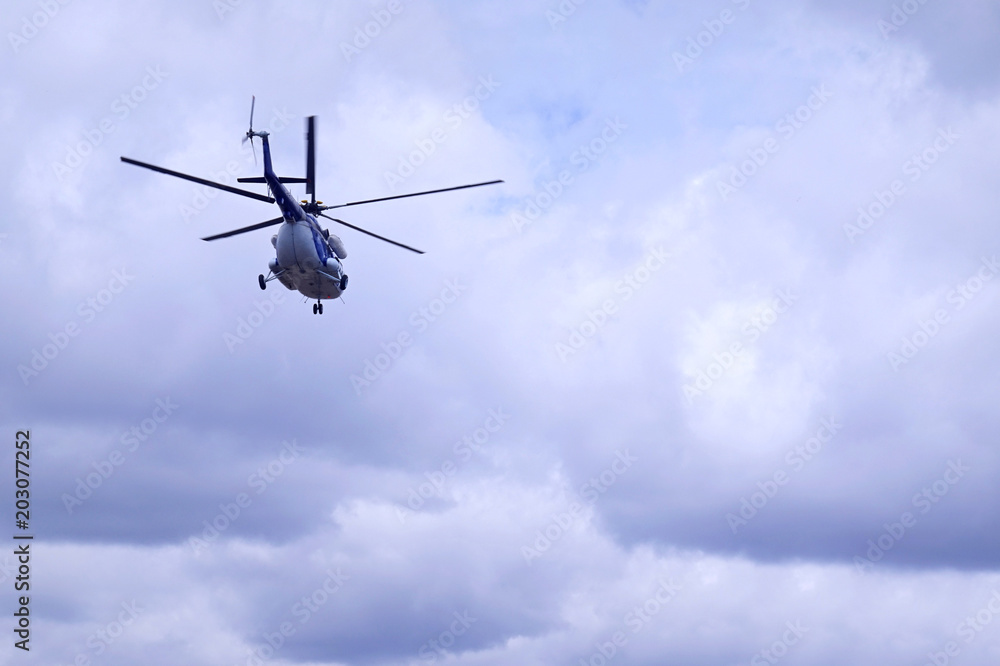 White blue helicopter on the sky background. Model MI-8 White blue helicopter on the sky background. Model MI-8