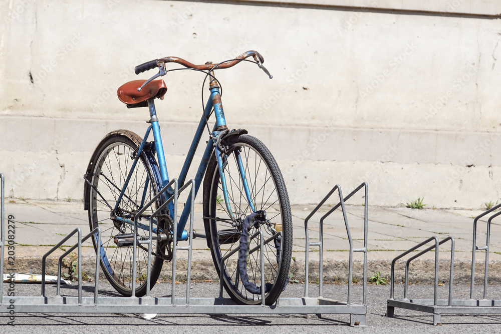 Bicycle parked in the street on the bicycle rack