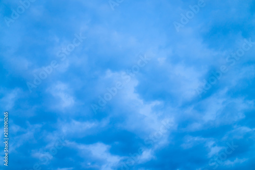 Fototapeta Naklejka Na Ścianę i Meble -  Cloudy blue twilight sky close-up. Overcast weather. Dramatic background from many rainy clouds.