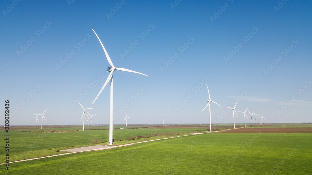 Wind power station on the field. Concept and idea of alternative energy development Wind power station on the field. Concept and idea of alternative energy development