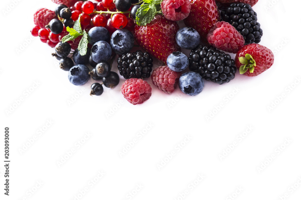 Fruits and berries isolated on white background. Ripe currants, raspberries, blueberries, strawberries and blackberries with a mint leaf. Sweet and juicy fruits with copy space for text. Top view. Fruits and berries isolated on white background. Ripe currants, raspberries, blueberries, strawberries and blackberries with a mint leaf. Sweet and juicy fruits with copy space for text. Top view.