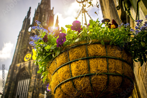 Flower basket with the royal mile cathedral on the background on the streets of Edinburgh  photo