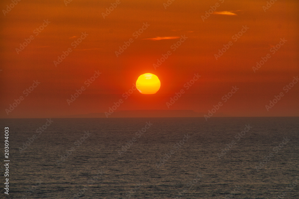The sun setting over the Pacific Ocean off the coast of California.